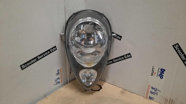 Sym Mio / 2014 / Koplamp zonder fitting, Fietsen en Brommers, Brommeronderdelen | Scooters, Koplamp, Overige merken, Ophalen of Verzenden