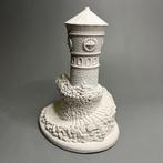 Figurine - White resin figurine depicting a stone tower with