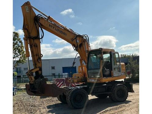 Online veiling - Hyundai Robex140W-7 Banden graafmachine, Zakelijke goederen, Machines en Bouw | Kranen en Graafmachines, Ophalen