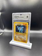 Pokémon - 1 Graded card - Machamp 8 First edition, Holo - GG, Hobby en Vrije tijd, Nieuw