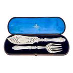 Sterling silver fish servers with water lilies, putto and