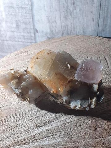 Beautiful pink fluorite crystal on cluster of mica and quart
