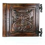 Elegant carved wooden relief with floral motif and crown -