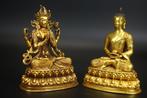 Two gilded bronze statues, one of the four-armed Guanyin and