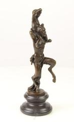 Figuur - A BRONZE SCULPTURE OF A FAUN WITH LITTLE BACCHUS
