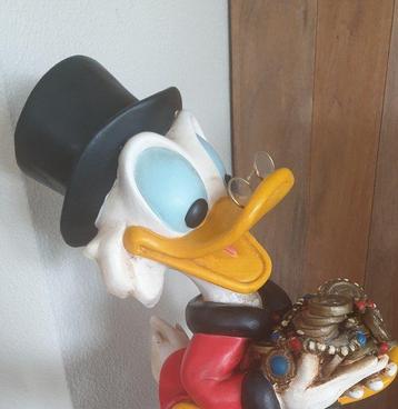Uncle Scrooge sitting on his treasure box with original
