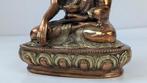 Kleine oude/antieke Oosterse boeddha op lotusbloem. - Koper