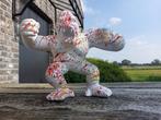 Statue, sculpture of a roaring monkey painted with running