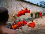 Steve McCurry (1950-) - Monk Running on Wall, 2004