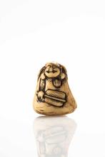 A nice stag-antler netsuke depicting happy Hotei  one of