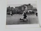 Robert Capa - Woman and dog running for shelter when the